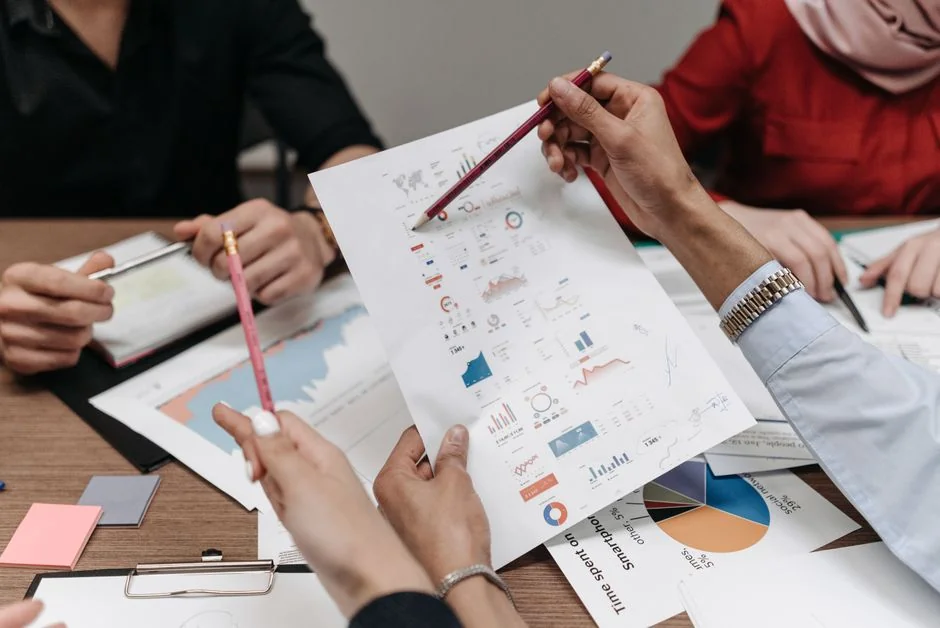 Two colleagues collaborate on a marketing strategy using a whiteboard, focusing on user-generated content.